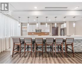 A modern kitchen with a dining table set for six.