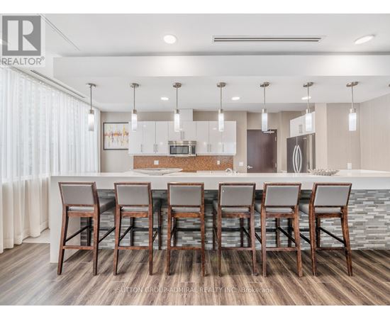 A modern kitchen with a dining table set for six.