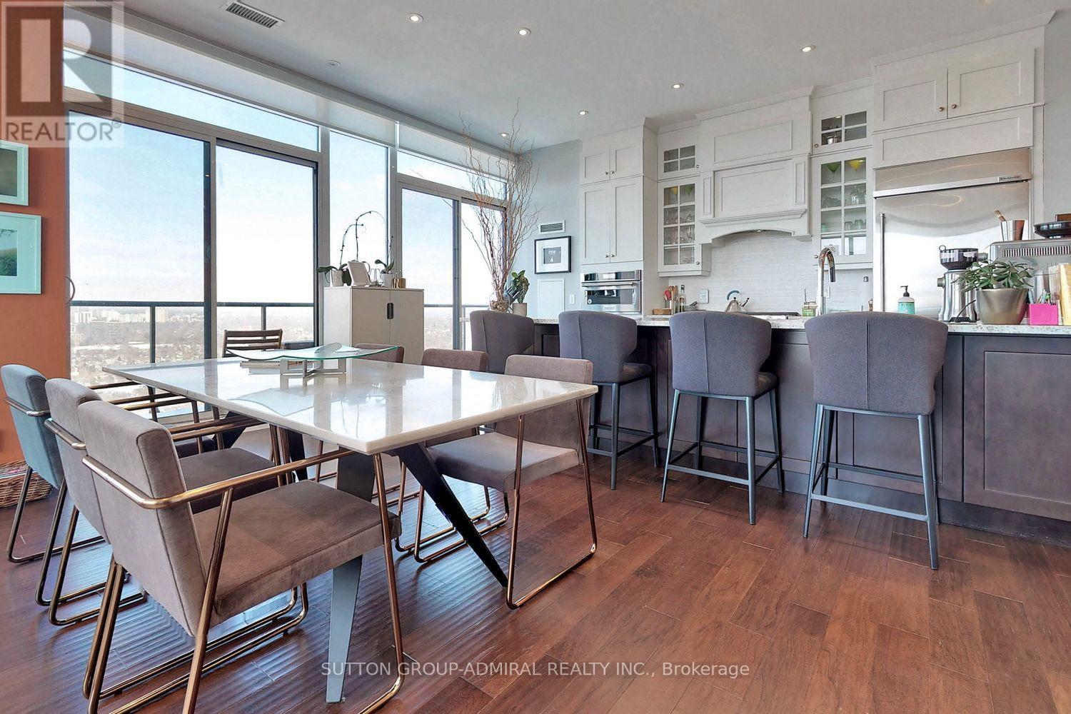 A dining room with a table and chairs.
