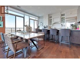A dining room with a table and chairs.