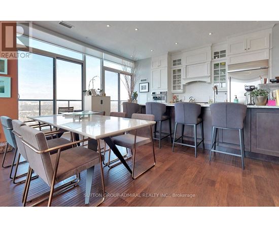 A dining room with a table and chairs.