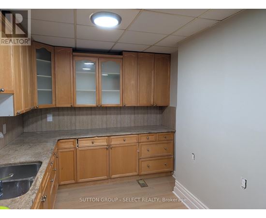 A kitchen with wooden cabinets and a countertop.