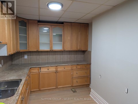 A kitchen with wooden cabinets and a countertop.