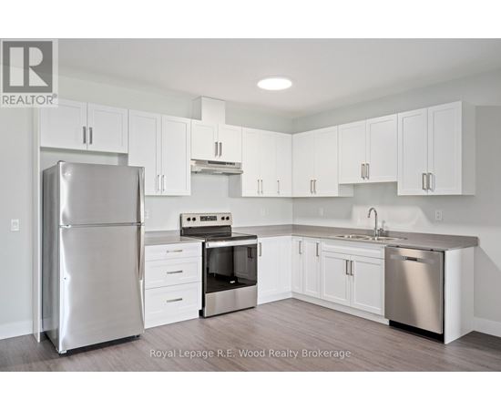 A kitchen with white cabinets and stainless steel appliances.