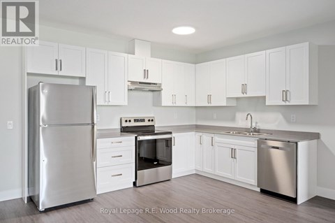 A kitchen with white cabinets and stainless steel appliances.