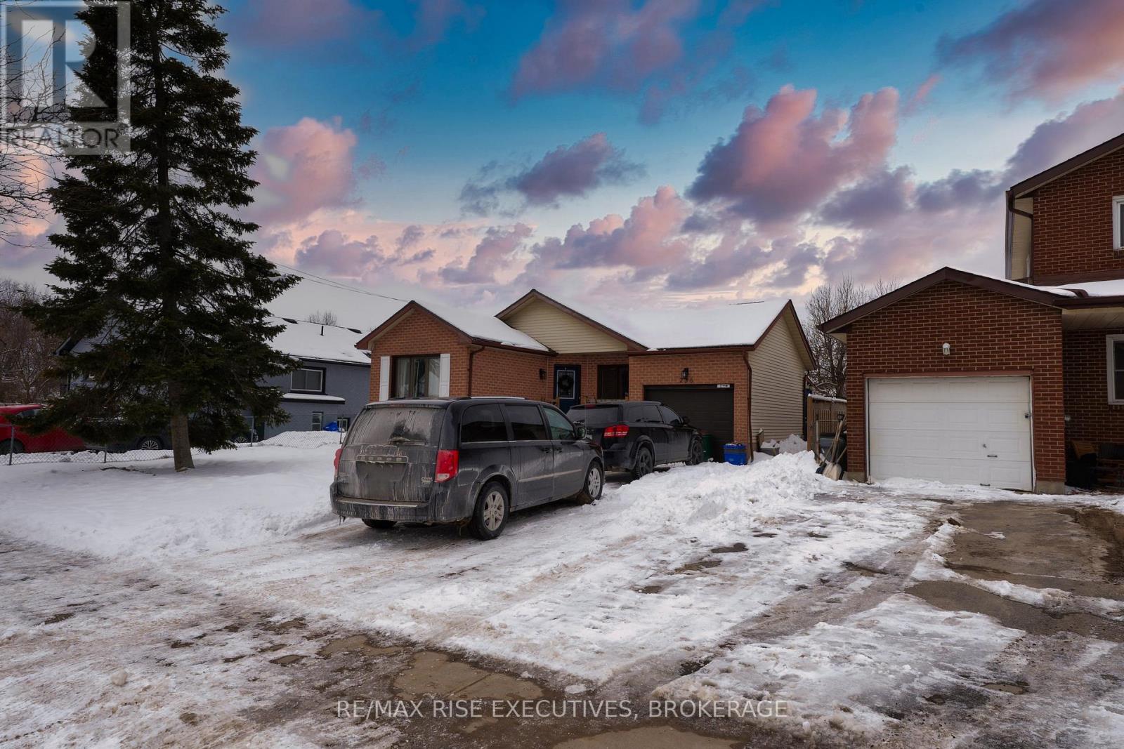 A house with a car parked in front of it.