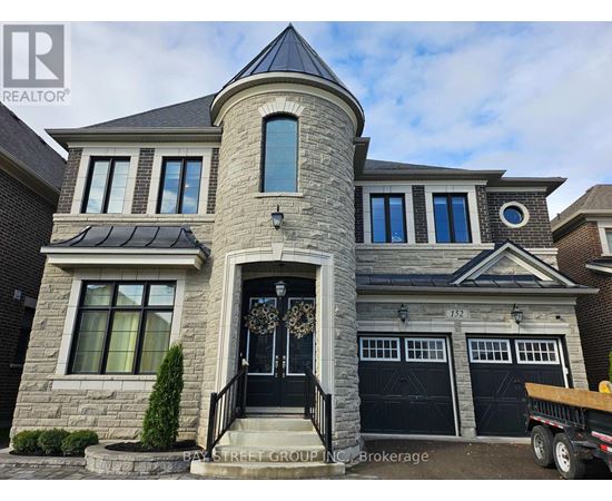 A large house with a stone facade and a black door.