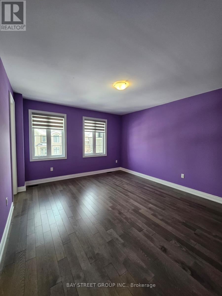 A room with purple walls and wooden flooring.