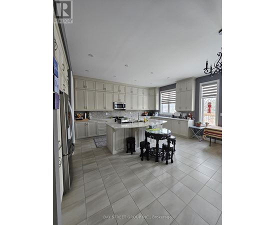 A kitchen with a table and chairs in the middle of the room.