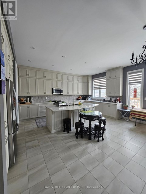 A kitchen with a table and chairs in the middle of the room.