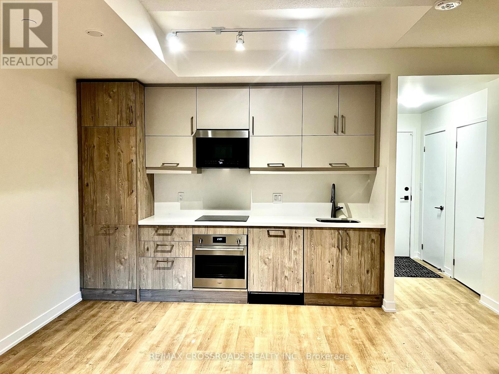 A kitchen with wooden cabinets and a white countertop.