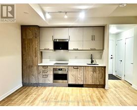 A kitchen with wooden cabinets and a white countertop.