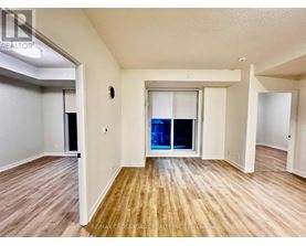 A room with wooden flooring and a sliding glass door.