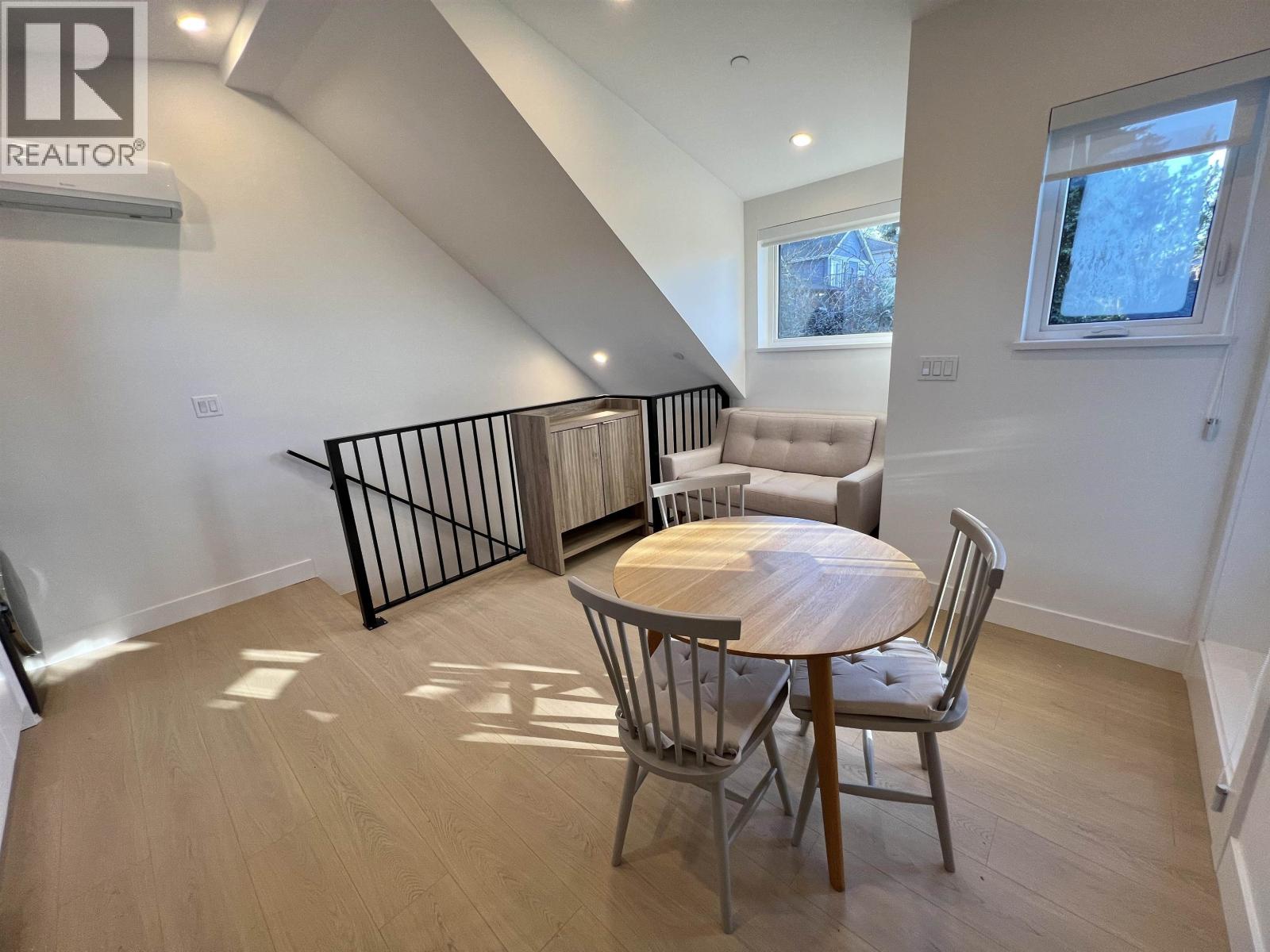 A dining room with a table and chairs is shown.