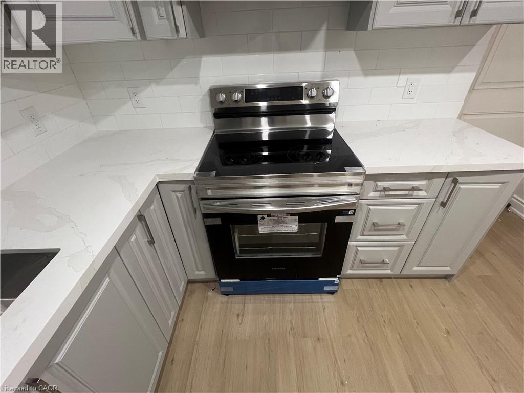 A kitchen with a stove top oven and a range hood.