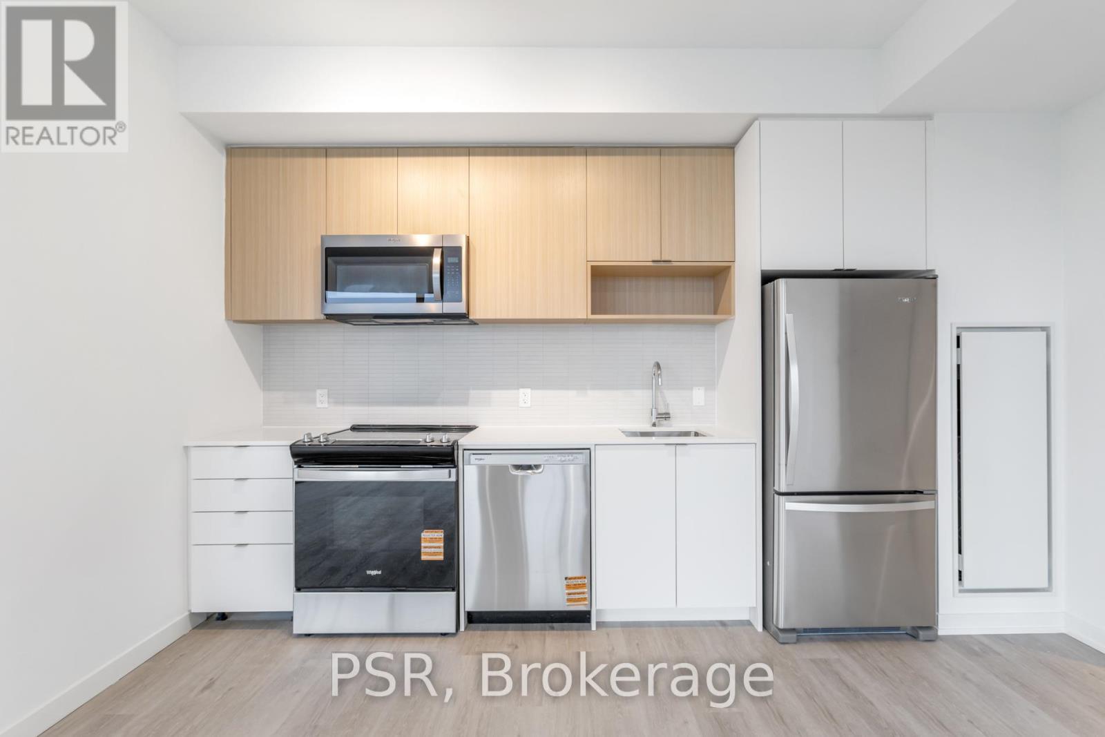 A kitchen with white cabinets and stainless steel appliances.