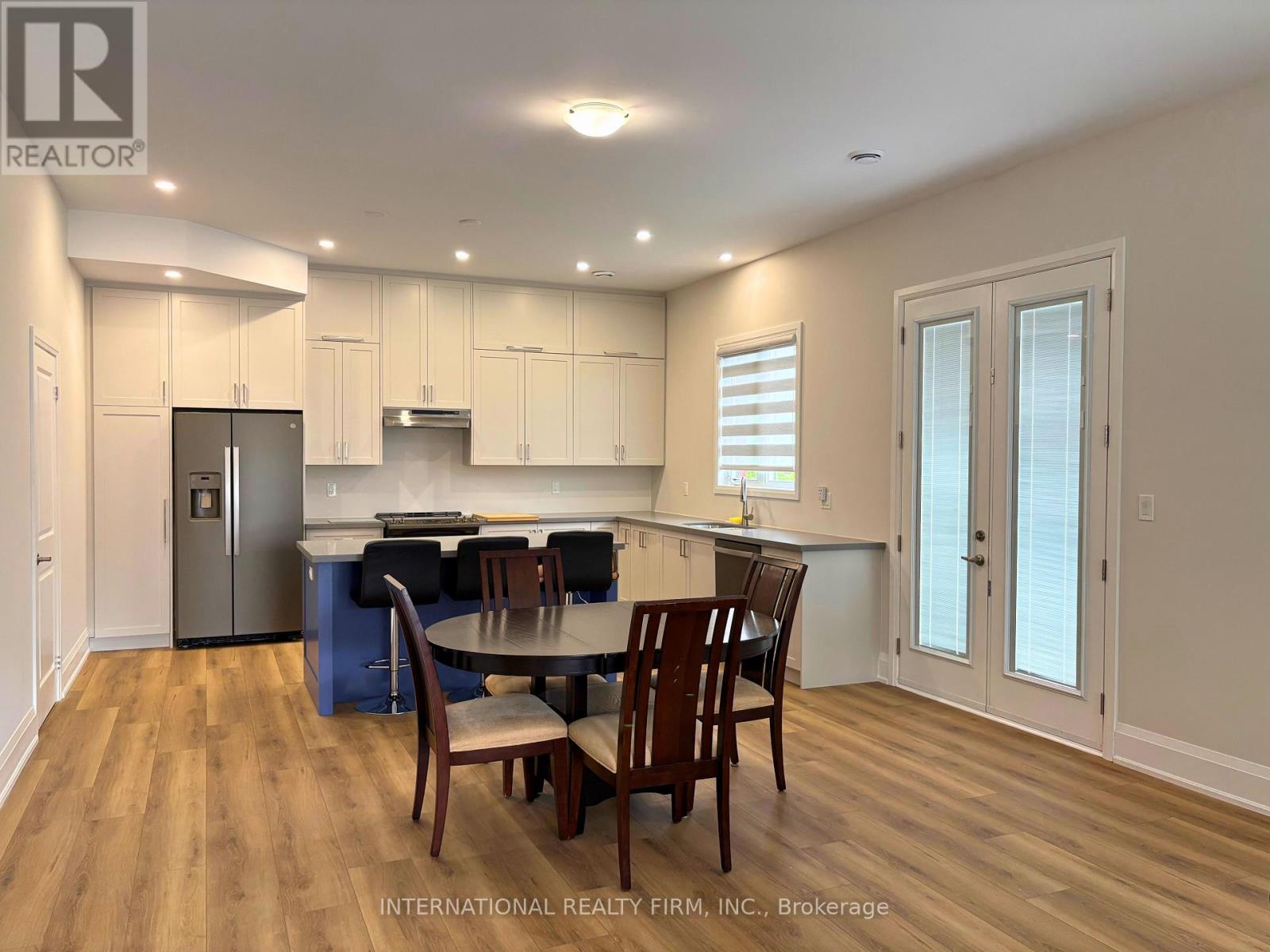 A modern kitchen with a dining table set up.