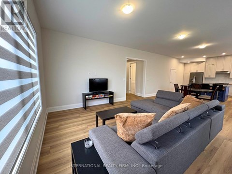 A living room with a grey sofa and a television.