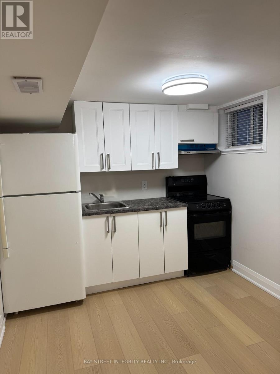 A kitchen with white cabinets and a black stove top oven.