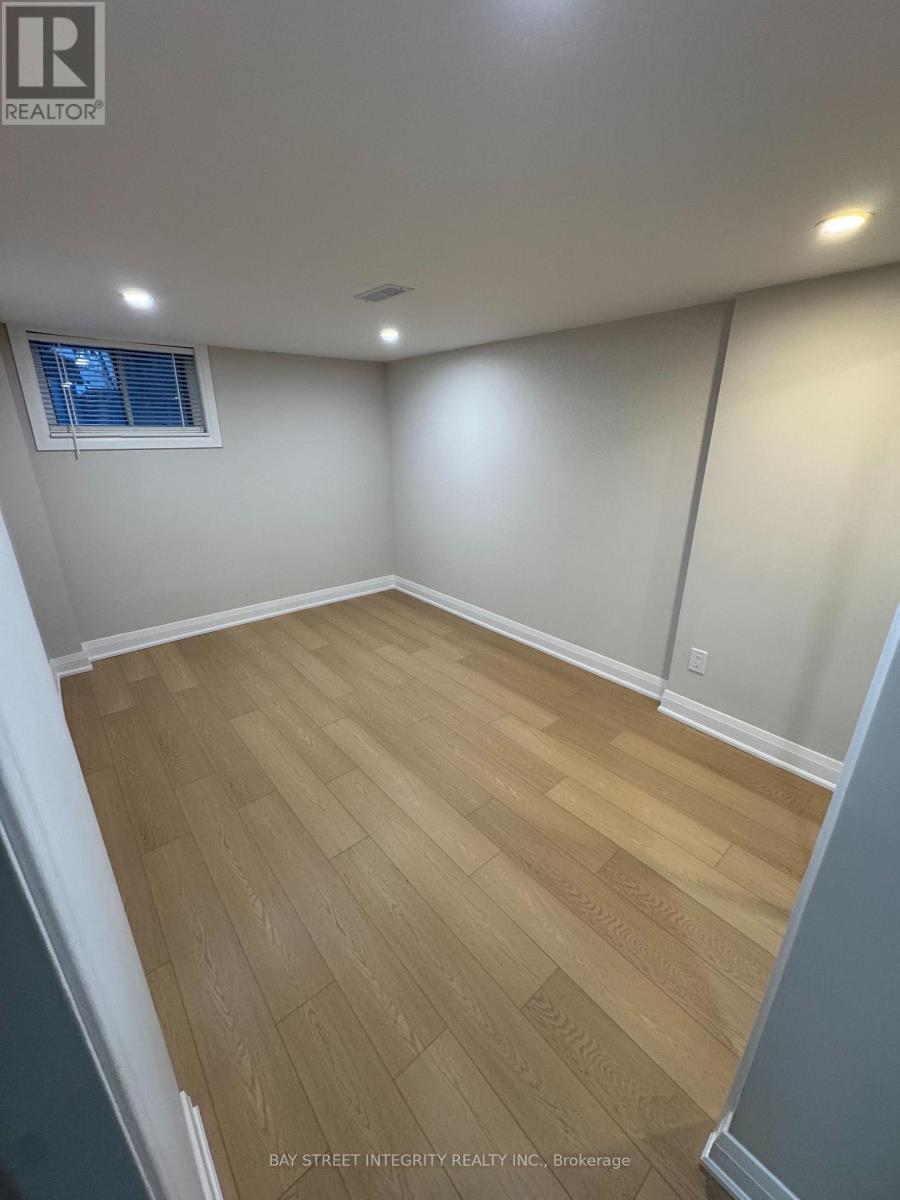 A room with wooden flooring and white walls.