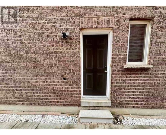 A brick wall with a door and a window.