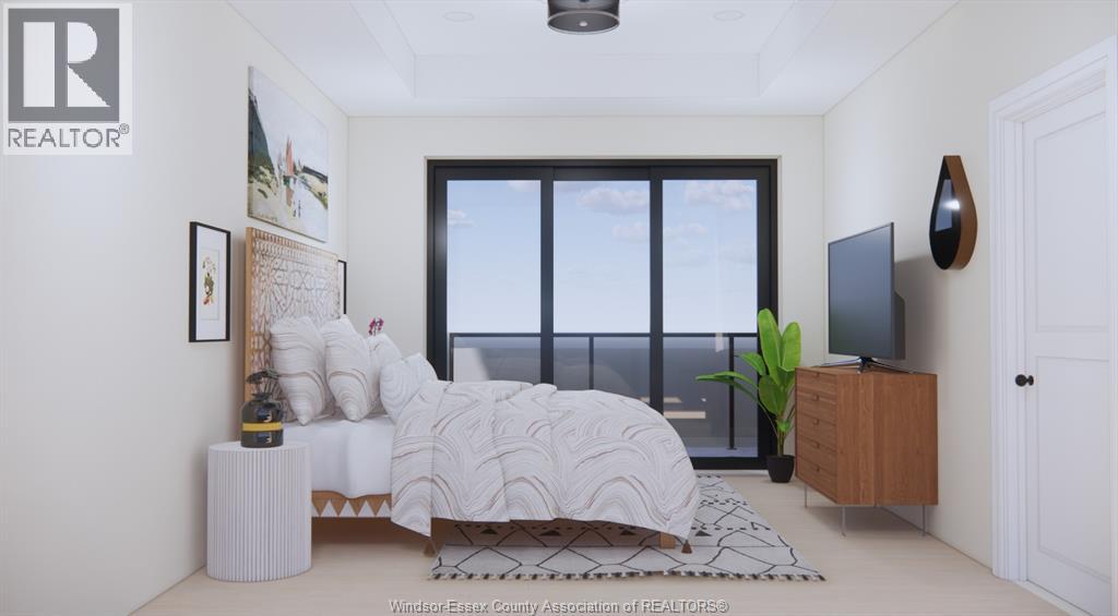A bedroom with a large bed and a window overlooking the water.