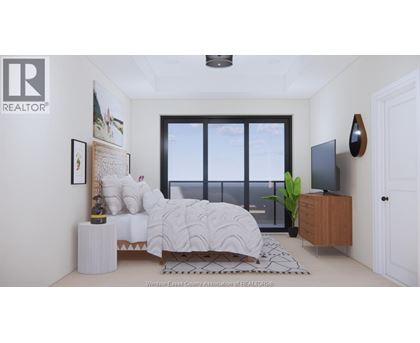 A bedroom with a large bed and a window overlooking the water.