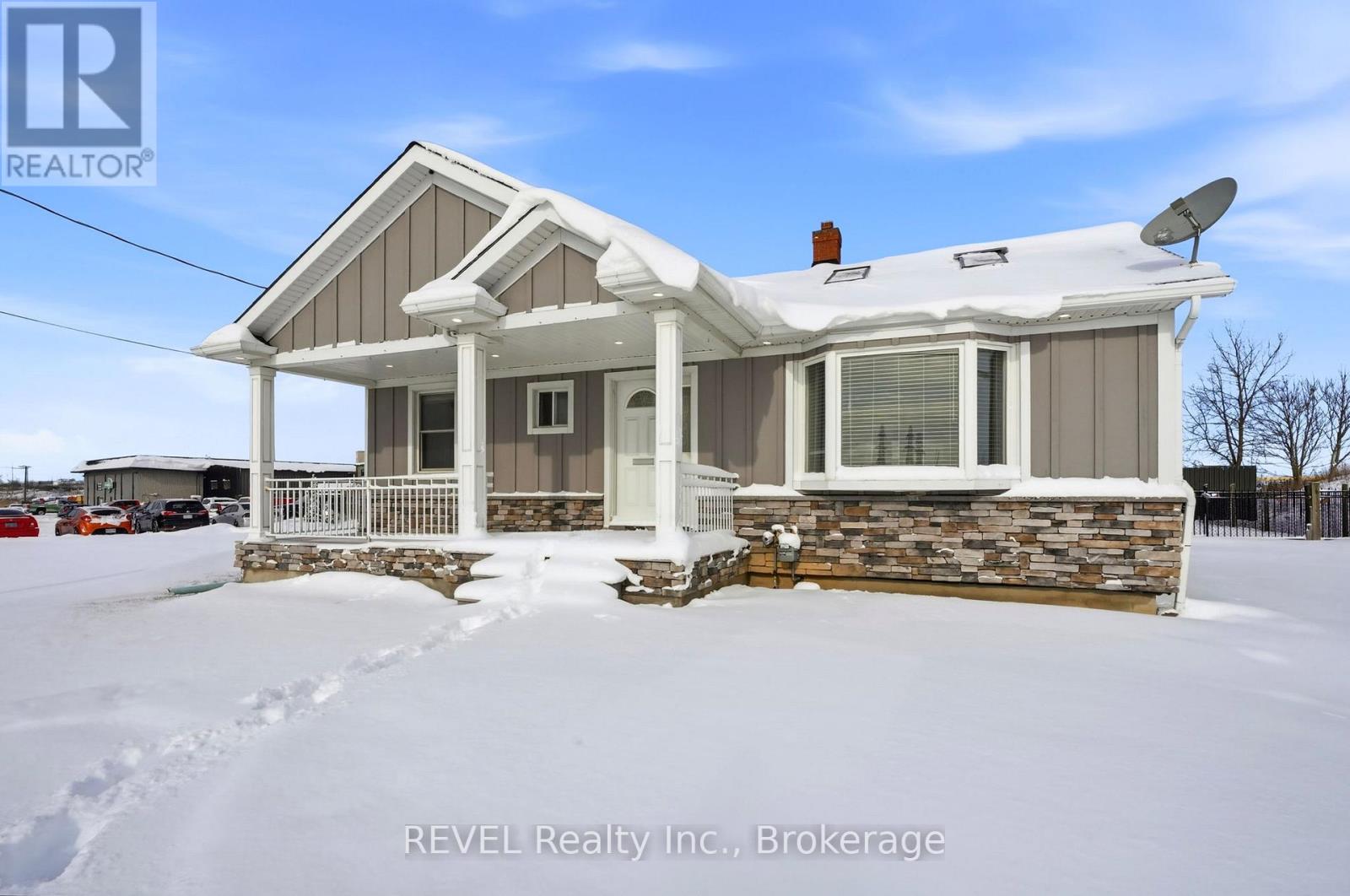 A house with a snowy front yard.