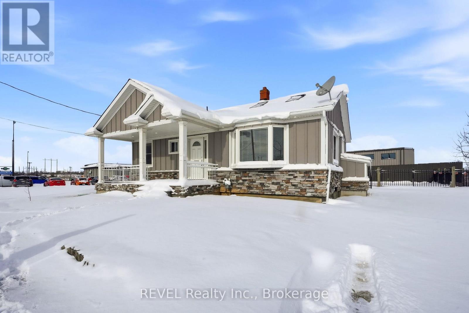 A house with a snowy front yard is for sale.