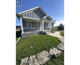 A house with a snowy front yard is for sale.