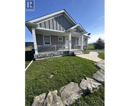 A house with a snowy front yard is for sale.