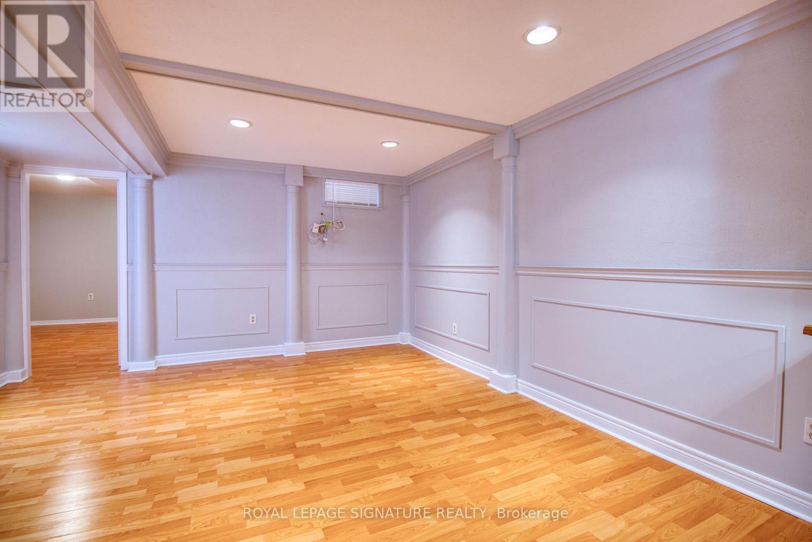 A room with wooden floors and white walls.