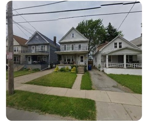 A row of houses with a blue house on the left and a white house on the right.