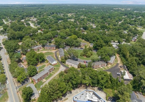 A bird's eye view of a residential area with a swimming pool.