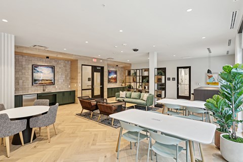 A modern dining room with a white table and chairs.