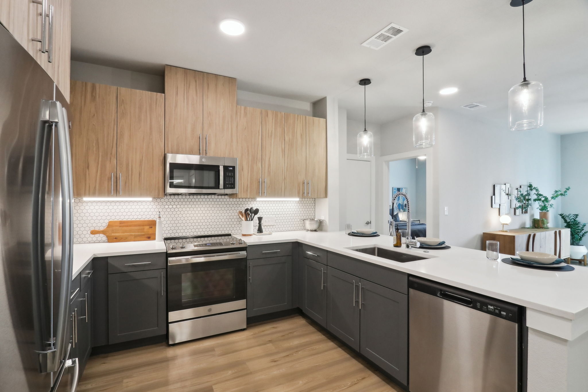 A modern kitchen with wooden cabinets and stainless steel appliances.
