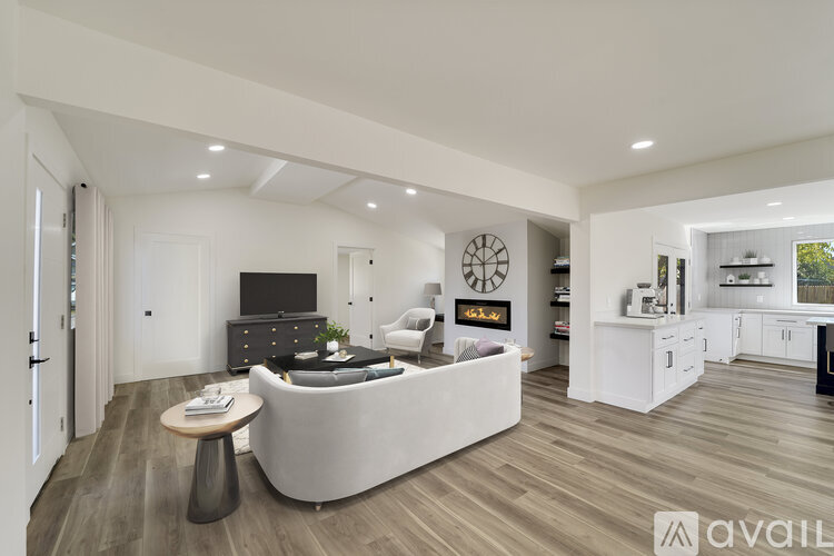 A modern living room with a grey sofa and a wooden coffee table.