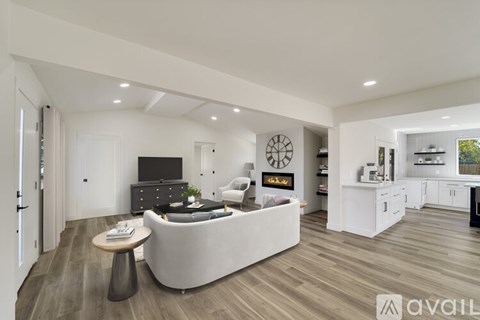 A modern living room with a grey sofa and a wooden coffee table.