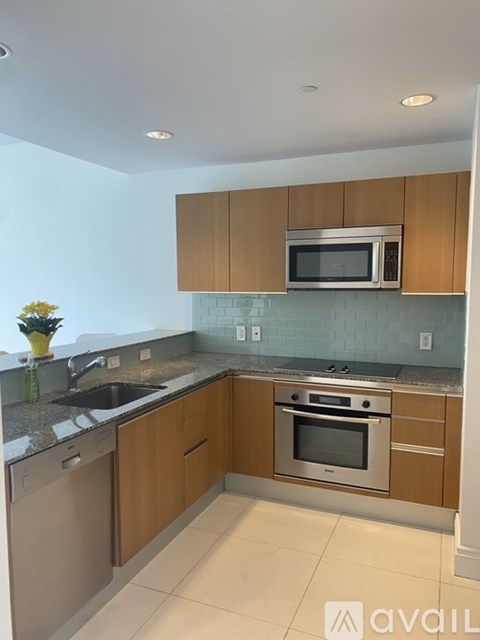 A kitchen with wooden cabinets and stainless steel appliances.