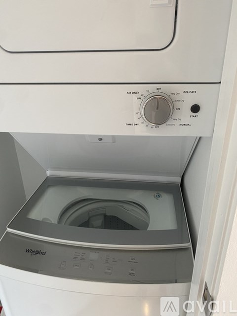 A white Whirlpool washing machine with the door open.