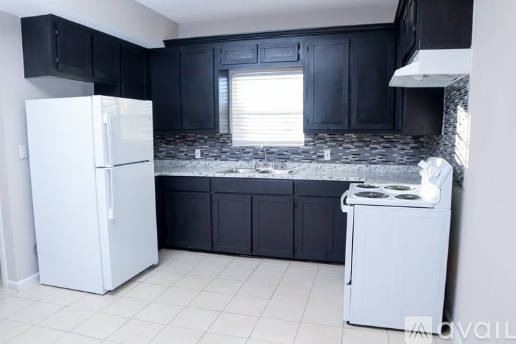 A kitchen with a white fridge and a white stove.