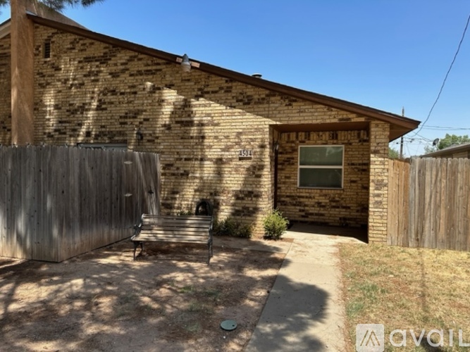 A house with a wooden fence and a window is for sale.
