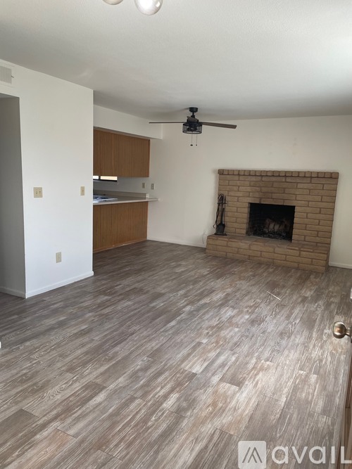 A living room with a fireplace and wooden flooring.