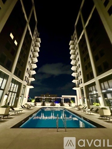 A swimming pool in the middle of a courtyard surrounded by buildings.