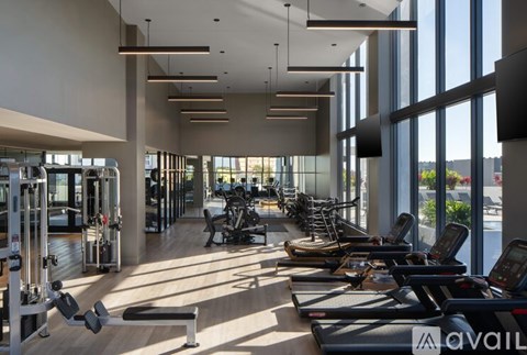 A gym with treadmills, weights, and exercise machines.