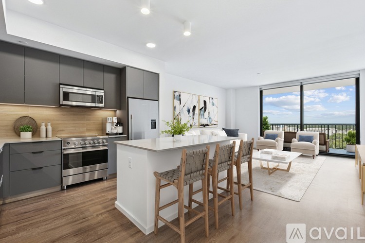 A modern kitchen with a dining table and chairs.