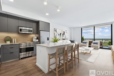 A modern kitchen with a dining table and chairs.