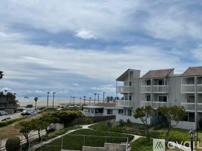 Apartment complex with a view of the beach and ocean.