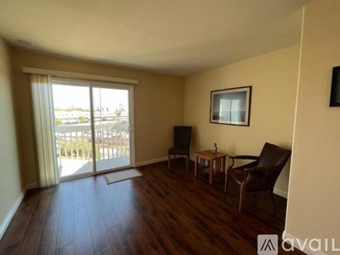 A living room with a brown leather chair and a small wooden table.