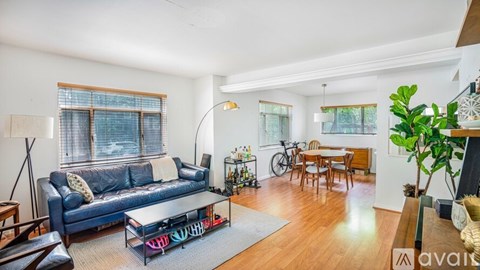 A living room with a blue couch and a coffee table.
